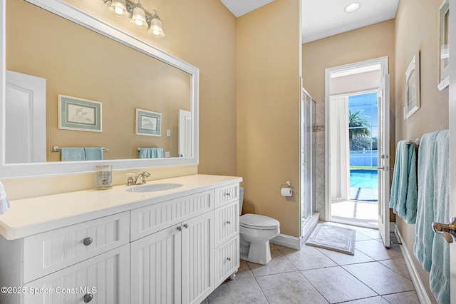 full bathroom featuring tile patterned floors, vanity, toilet, and a shower stall