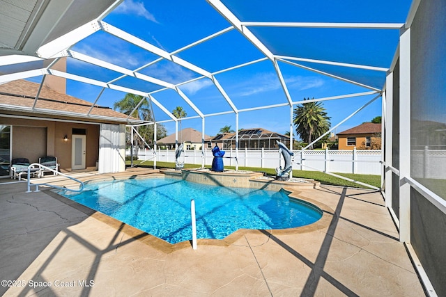 view of swimming pool featuring a fenced in pool, a hot tub, glass enclosure, a fenced backyard, and a patio area