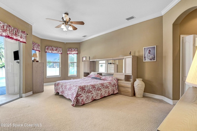 bedroom with arched walkways, visible vents, carpet flooring, and access to outside