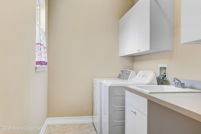 washroom with baseboards, cabinet space, washing machine and dryer, and light tile patterned flooring