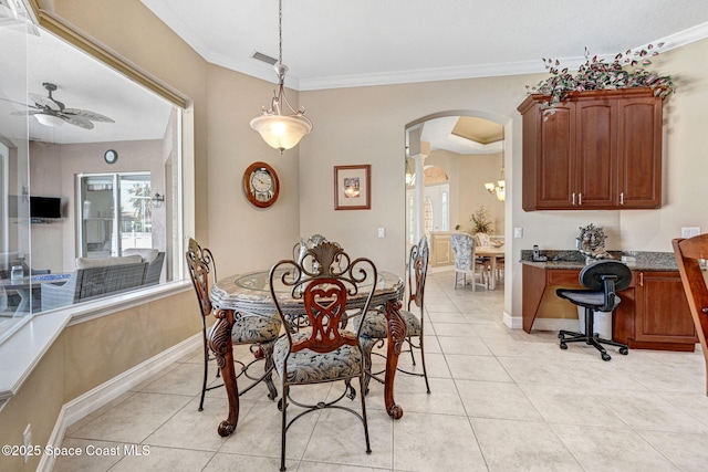 dining space with visible vents, ornamental molding, arched walkways, light tile patterned flooring, and ceiling fan