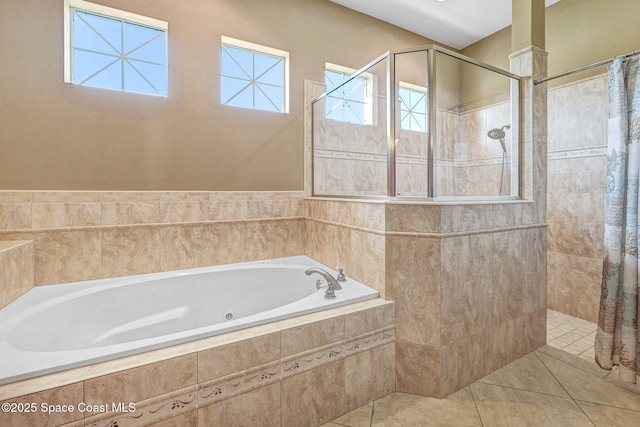 full bath with tile patterned floors, a bath, and a tile shower