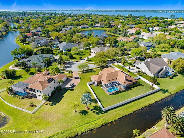 birds eye view of property featuring a residential view and a water view