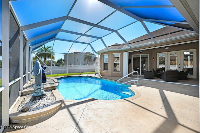 view of swimming pool with a fenced in pool, glass enclosure, french doors, outdoor lounge area, and a patio area