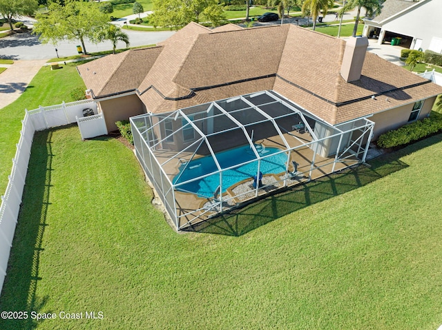 view of pool with a lawn, a fenced backyard, a fenced in pool, a lanai, and a patio area