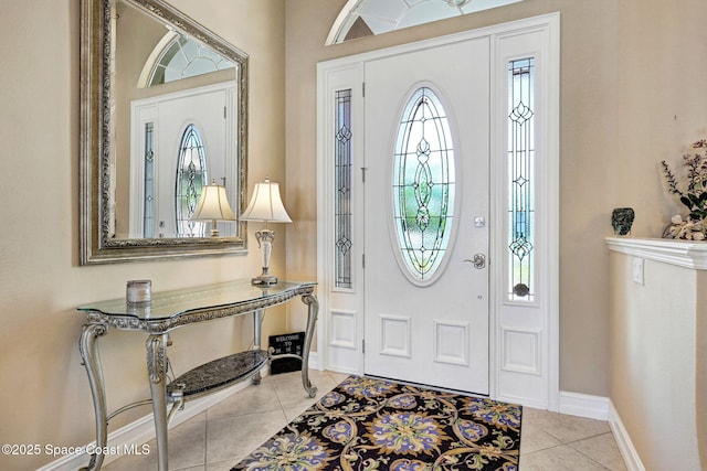 entryway with light tile patterned floors and baseboards