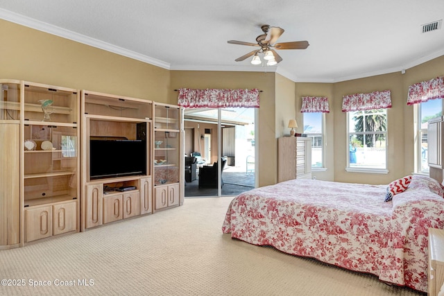 bedroom with visible vents, carpet, crown molding, and access to outside