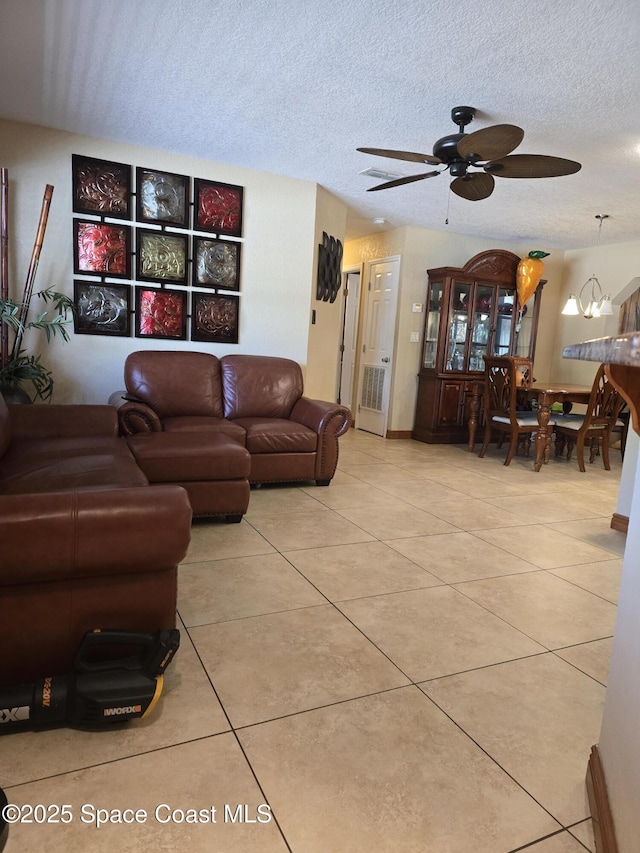 2013 Rollins Dr, Cocoa, FL 32922 - living area featuring ceiling fan, light tile patterned flooring, and a textured ceiling