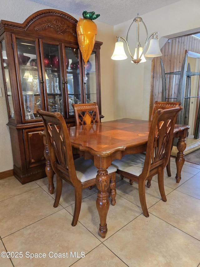 2013 Rollins Dr, Cocoa, FL 32922 - dining area with a chandelier, light tile patterned floors, and a textured ceiling