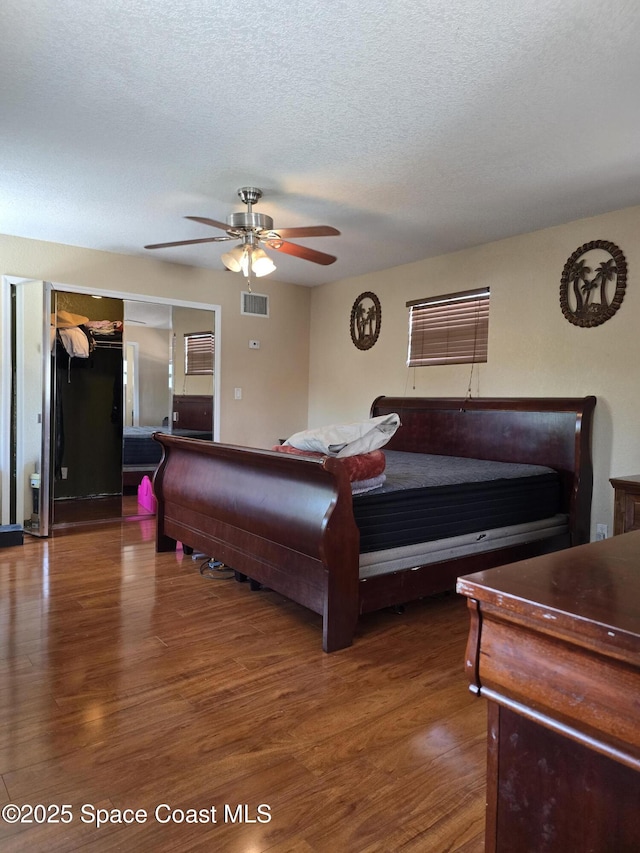 2013 Rollins Dr, Cocoa, FL 32922 - bedroom featuring wood finished floors, a textured ceiling, and a ceiling fan