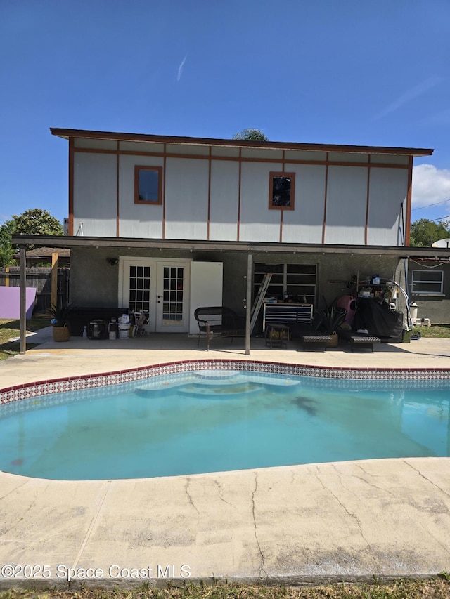 2013 Rollins Dr, Cocoa, FL 32922 - outdoor pool with french doors, a patio, and fence