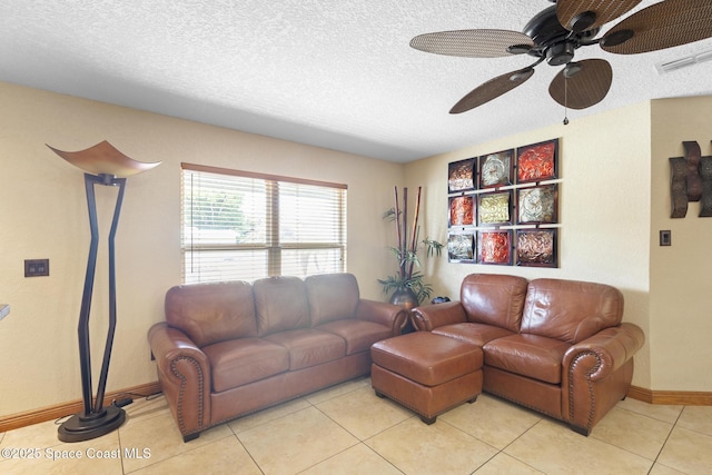 2013 Rollins Dr, Cocoa, FL 32922 - living area with ceiling fan, a textured ceiling, baseboards, and light tile patterned flooring
