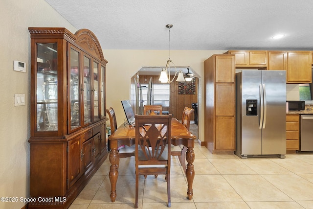 2013 Rollins Dr, Cocoa, FL 32922 - dining area featuring a chandelier, a textured ceiling, and light tile patterned floors