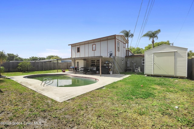 2013 Rollins Dr, Cocoa, FL 32922 - back of house with board and batten siding, a storage unit, a patio area, central AC unit, and an outdoor structure