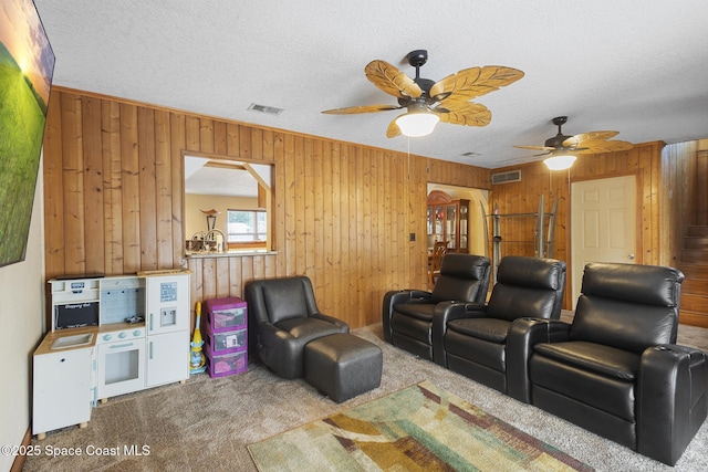 2013 Rollins Dr, Cocoa, FL 32922 - carpeted cinema room with wooden walls, a ceiling fan, and a textured ceiling