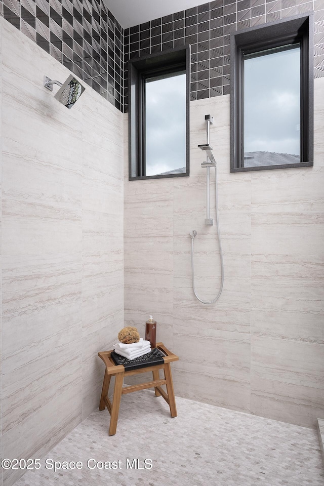 bathroom with a tile shower