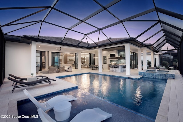 pool with an outdoor hangout area, an in ground hot tub, a ceiling fan, outdoor dry bar, and a patio area