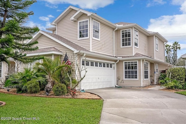 traditional-style home with concrete driveway, a shingled roof, and an attached garage