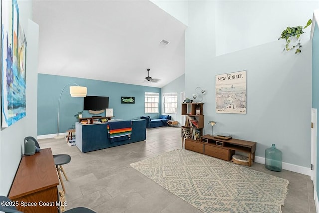 living room with ceiling fan, a towering ceiling, visible vents, and baseboards