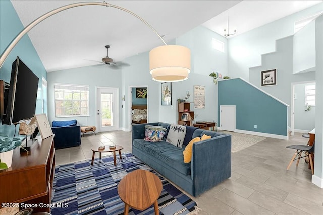 living room with baseboards, plenty of natural light, high vaulted ceiling, and a ceiling fan