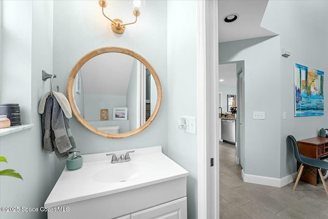 bathroom with vanity and baseboards