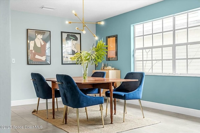 dining area featuring visible vents, baseboards, and a chandelier