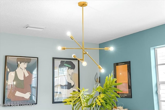 details featuring a textured ceiling and visible vents