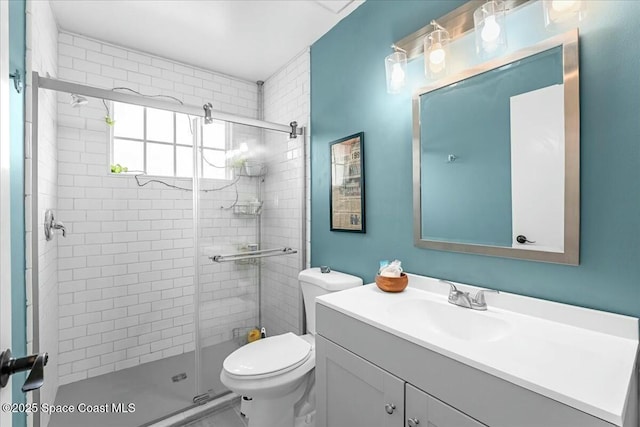 full bathroom featuring toilet, a shower stall, and vanity