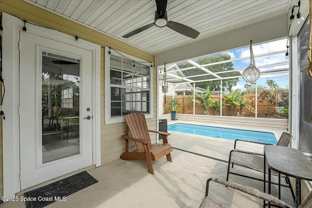 sunroom featuring a ceiling fan and a healthy amount of sunlight