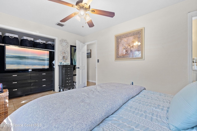 bedroom with visible vents, a ceiling fan, and tile patterned floors