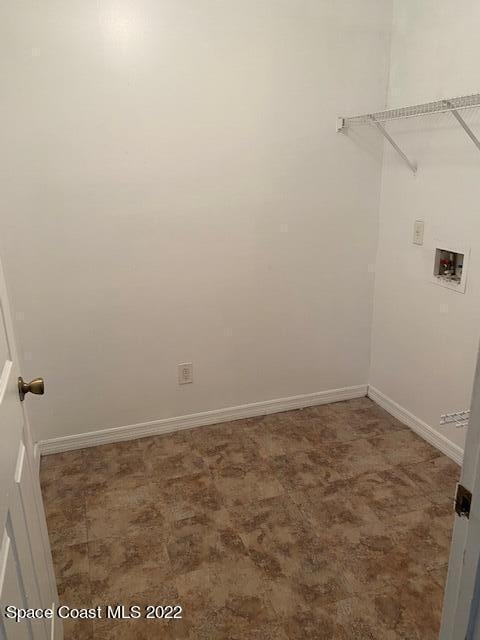 laundry area featuring washer hookup, laundry area, carpet flooring, and baseboards