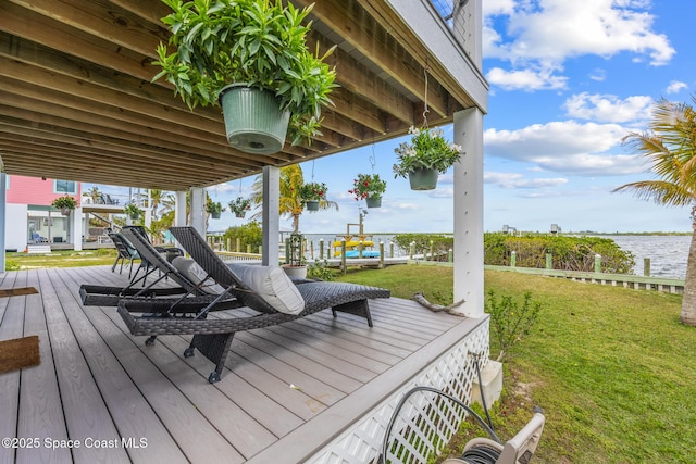 deck featuring a water view and a yard