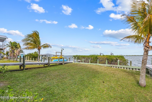 view of yard featuring a dock and a water view