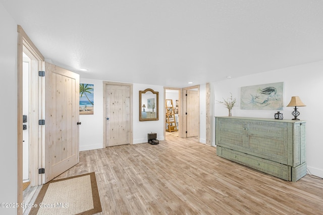 foyer with wood finished floors and baseboards