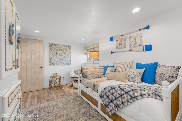 bedroom with recessed lighting, baseboards, and wood finished floors