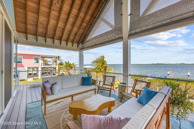 wooden deck featuring a water view and an outdoor living space