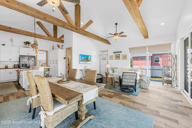 dining area with light wood finished floors, recessed lighting, ceiling fan, high vaulted ceiling, and beamed ceiling