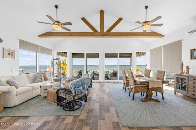 living room featuring high vaulted ceiling, a water view, ceiling fan, and wood finished floors