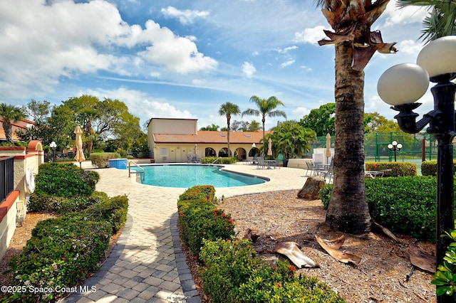 pool featuring a patio area and fence