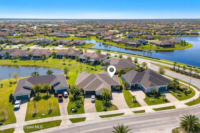 bird's eye view with a residential view and a water view