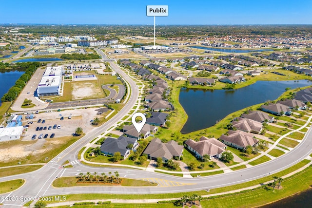 drone / aerial view with a water view and a residential view