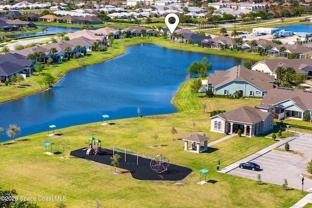 drone / aerial view featuring a residential view and a water view