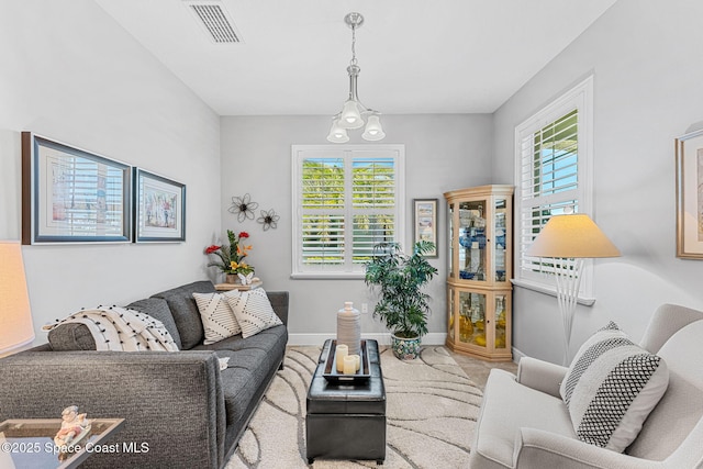 living area with visible vents and baseboards