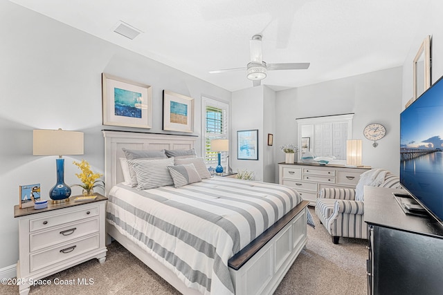 bedroom featuring light carpet and ceiling fan