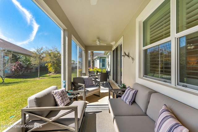 sunroom / solarium featuring ceiling fan