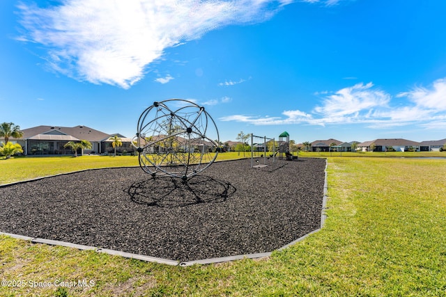 community jungle gym featuring a residential view and a yard