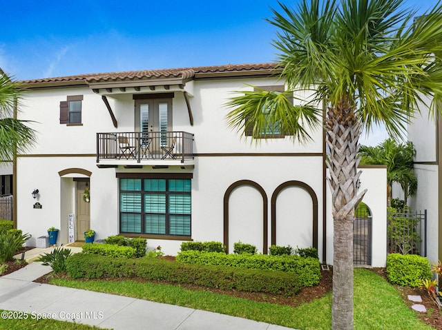 mediterranean / spanish-style house with stucco siding and a tiled roof