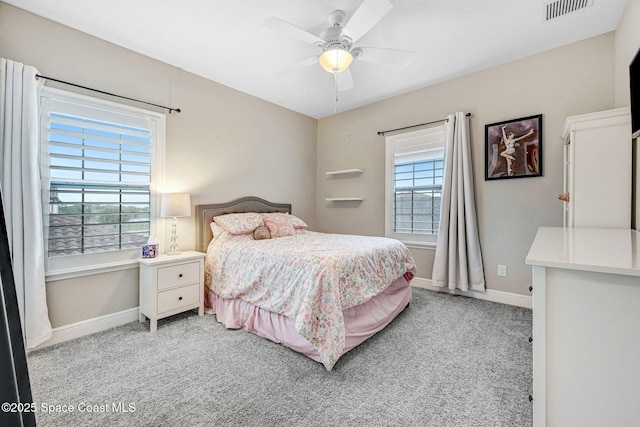 bedroom with light carpet, visible vents, ceiling fan, and baseboards