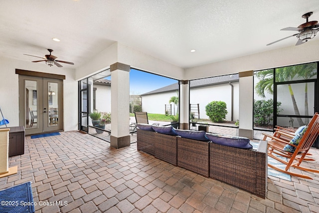 interior space with an outdoor living space, french doors, and ceiling fan