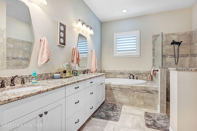 bathroom with a sink, walk in shower, a bath, and double vanity